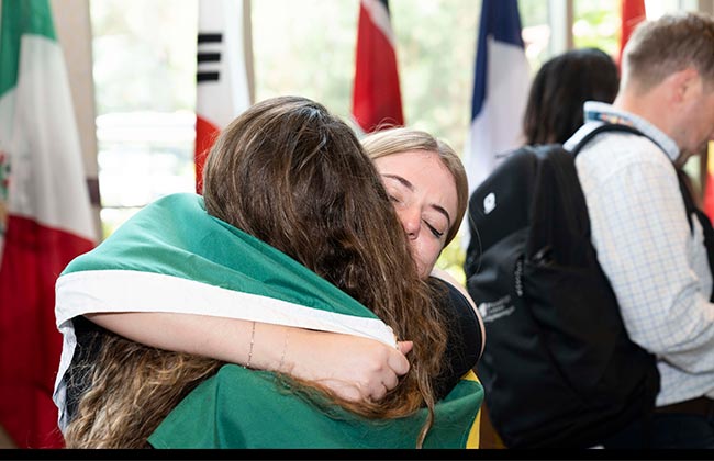 Two female students embracing after the competition