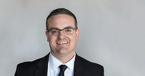 Middle-aged caucasian male with dark hair and glasses