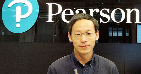 Asian man with glasses and a black dress shirt