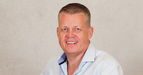 Middle-aged caucasian male in a blue button up shirt