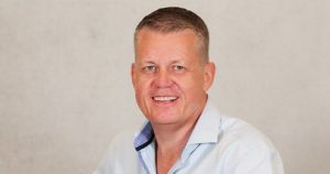 Middle-aged caucasian male in a blue button up shirt