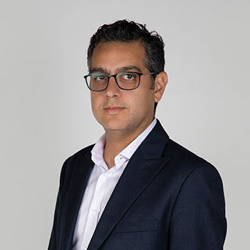 Middle-aged middle eastern male with dark hair and glasses