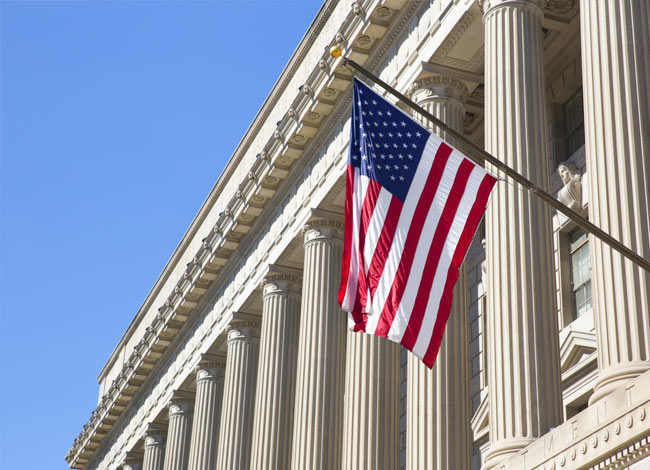 U.S. flag in front of white building