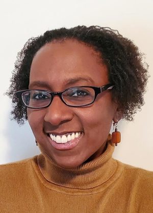 Tamika Hughes, an African American woman wearing glasses
